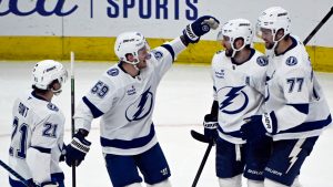 Tampa Bay Lightning right wing Nikita Kucherov, second from right, celebrates with teammates after scoring the winning goal during overtime of their game against the Chicago Blackhawks. (AP Photo/Matt Marton)