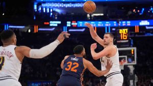 Denver Nuggets' Nikola Jokic, right, passes to Russell Westbrook, left, as New York Knicks' Karl-Anthony Towns defends during the second half of an NBA basketball game Wednesday, Jan. 29, 2025, in New York. (Frank Franklin II/AP)