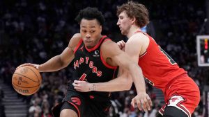 Toronto Raptors forward Scottie Barnes (4) drives past Chicago Bulls forward Matas Buzelis (14) during second half NBA basketball action in Toronto, Friday, Jan. 31, 2025. (Nathan Denette/CP)