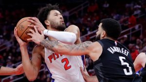 Detroit Pistons guard Cade Cunningham (2) protects the ball on a drive to the basket as Houston Rockets guard Fred VanVleet (5) reaches in during the first half of an NBA basketball game. (Michael Wyke/AP)