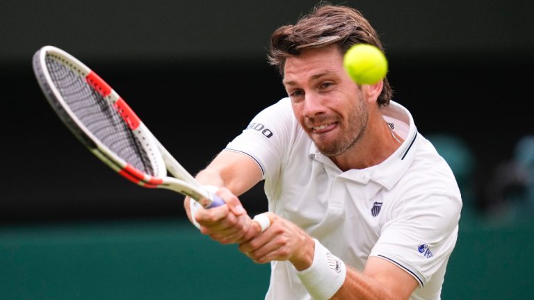 Cameron Norrie of Britain plays a backhand return to Alexander Zverev of Germany during their third round match at the Wimbledon tennis championships in London, Saturday, July 6, 2024. (Kirsty Wigglesworth/AP)