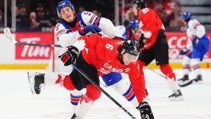 USA's Ryan Leonard (9) and Canada's Tanner Molendyk (6) collide during first period IIHF World Junior Hockey Championship tournament action in Ottawa on Tuesday, Dec. 31, 2024. (Sean Kilpatrick/CP)