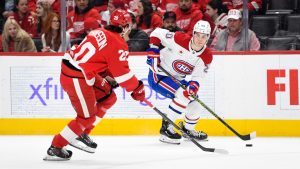 Montreal Canadiens left wing Juraj Slafkovsky, right, keeps the puck away from Detroit Red Wings defenseman Albert Johansson during the first period of an NHL hockey game, Thursday, Jan. 23, 2025, in Detroit. (Jose Juarez/AP)