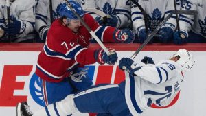 Montreal Canadiens' Arber Xhekaj (72) checks Toronto Maple Leafs' Ryan Reaves (75) during second period NHL hockey action in Montreal on Saturday, Jan. 18, 2025. (Christinne Muschi/CP)