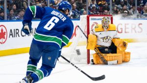 Nashville Predators goaltender Juuse Saros (74) watches as Vancouver Canucks Brock Boeser (6) prepares to shoot during the first period of an NHL hockey game in Vancouver, on Friday, January 3, 2025. (Ethan Cairns/CP)