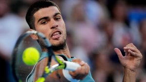 Carlos Alcaraz of Spain plays a forehand return to Alexander Shevchenko of Kazakhstan during their first round match at the Australian Open tennis championship in Melbourne, Australia, Monday, Jan. 13, 2025. (AP Photo/Vincent Thian)