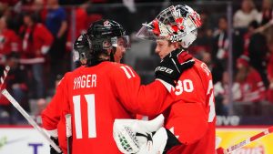 Canada's Brayden Yager (11) consoles goaltender Carter George (30) after losing to the United States in IIHF World Junior Hockey Championship tournament action in Ottawa on Tuesday, Dec. 31, 2024. (Sean Kilpatrick/CP)