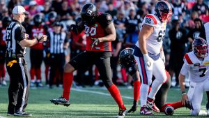 Ottawa Redblacks defensive lineman Cleyon Laing (90) celebrates after sacking Montreal Alouettes quarterback Cody Fajardo (7) during the first half of CFL football action in Ottawa, on Saturday, Sept. 21, 2024. (Spencer Colby/CP)