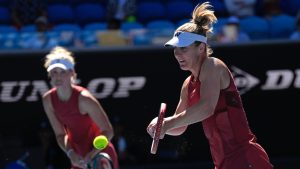 Canada's Gabriela Dabrowski, right, and partner Erin Routliffe of New Zealand in action their women's doubles semifinal against Hsieh Su-Wei of Taiwan and Jelena Ostapenko of Latvia at the Australian Open tennis championship in Melbourne, Australia, Friday, Jan. 24, 2025. (Ng Han Guan/AP)