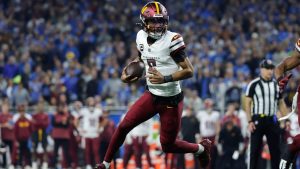 Washington Commanders quarterback Jayden Daniels (5) looks to run the ball against the Detroit Lions during the first half of an NFL football divisional playoff game, Saturday, Jan. 18, 2025, in Detroit. (Rey Del Rio/AP)