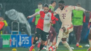 Feyenoord's Anis Hadj Moussa, left, duels for the ball with Bayern's Alphonso Davies during the Champions League opening phase soccer match between Feyenoord and Bayern Munich, at De Kuip Stadium, in Rotterdam, Netherlands, Wednesday, Jan. 22, 2025. (AP Photo/Peter Dejong)