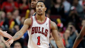 Chicago Bulls guard Derrick Rose (1) celebrates with teammates after scoring a free-throw shot during the second half of an NBA preseason basketball game against the Indiana Pacers in Chicago on Friday, Oct. 18, 2013. the Bulls won 103-98. (AP Photo/Nam Y. Huh)