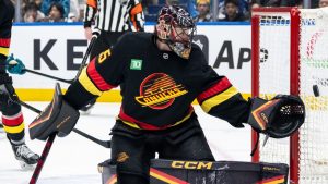 Vancouver Canucks goaltender Thatcher Demko (35) stops the puck against the San Jose Sharks during third period NHL hockey action in Vancouver, B.C., Monday, Dec. 23, 2024. (Ethan Cairns/CP)