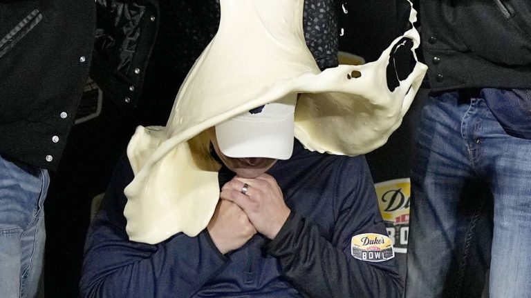 FILE - West Virginia head coach Neal Brown is dunked with mayonnaise after the team's win against North Carolina in an NCAA college football game at the Duke's Mayo Bowl Wednesday, Dec. 27, 2023, in Charlotte, N.C. (AP/Chris Carlson, File)