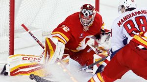 Washington Capitals' Andrew Mangiapane has a shot stopped by Calgary Flames goalie Dustin Wolf during second period NHL hockey action in Calgary, Tuesday, Jan. 28, 2025. (Larry MacDougal/CP)