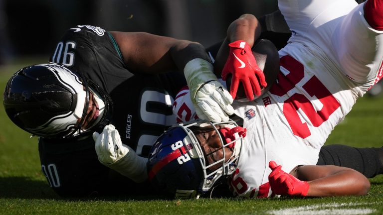 Philadelphia Eagles defensive tackle Jordan Davis (90) tackles New York Giants running back Devin Singletary (26) after a catch during the first half of an NFL football game Sunday, Jan. 5, 2025, in Philadelphia. (Matt Slocum/AP)