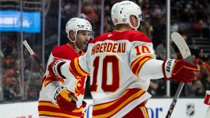 Calgary Flames center Nazem Kadri (91) celebrates his goal with center Jonathan Huberdeau (10) during the second period of an NHL hockey game against the Anaheim Ducks, Tuesday, Jan. 7, 2025, in Anaheim, Calif. (Kyusung Gong/AP)