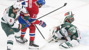 Minnesota Wild goaltender Marc-Andre Fleury (29) makes a save against Montreal Canadiens' Josh Anderson (17) during second period NHL hockey action in Montreal on Thursday, Jan. 30, 2025. (Christinne Muschi/CP)