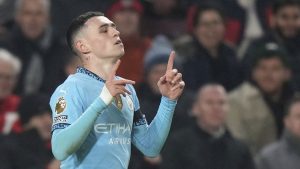 Manchester City's Phil Foden celebrates after scoring the opening goal against Brentford during the English Premier League soccer match between Brentford and Manchester City at the Gtech Community stadium, in London, England, Tuesday, Jan. 14, 2025. (Alastair Grant/AP)
