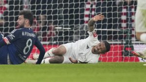 Arsenal's Gabriel Jesus, bottom right, reacts after injuring during the English FA Cup soccer match between Arsenal and Manchester United at the Emirates stadium in London, Sunday, Jan. 12, 2025. (Kin Cheung/AP)