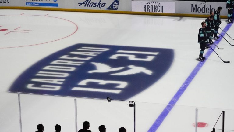 Seattle Kraken players stand for a moment of silence for Columbus Blue Jackets player Johnny Gaudreau and his brother Matthew Gaudreau, who were killed by a driver in New Jersey in August, before an NHL hockey game against the St. Louis Blues, Tuesday, Oct. 8, 2024, in Seattle. (Lindsey Wasson/AP)