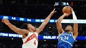 Milwaukee Bucks' Giannis Antetokounmpo (34) shoots against Toronto Raptors' Scottie Barnes (4) during the first half of an NBA basketball game. (Aaron Gash/AP)