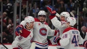 Montreal Canadiens' Kirby Dach is congratulated after scoring the winning goal by Mike Matheson Emil Heineman and Lane Hutson during the shootout of an NHL hockey game against the Colorado Avalanche Saturday, Jan. 4, 2025, in Denver. (David Zalubowski/AP)