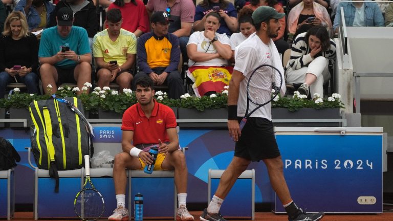 Hady Habib of Lebanon, right, walks by Carlos Alcaraz of Spain during the men's singles tennis competition, at the 2024 Summer Olympics, Saturday, July 27, 2024, in Paris, France. (Andy Wong/AP)