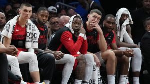 Miami Heat guard Tyler Herro, left, and center Bam Adebayo, far right, watch from the bench during the second half of an NBA basketball game against the Utah Jazz, Saturday, Jan. 4, 2025, in Miami. (Lynne Sladky/AP)