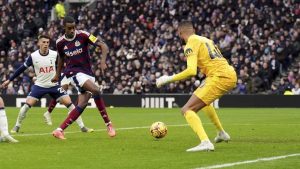 Newcastle United's Alexander Isak score past Tottenham's Brandon Austin during the English Premier League soccer match between Tottenham Hotspur and Newcastle United. (John Walton/PA via AP)