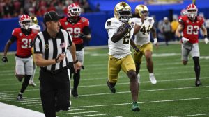 Notre Dame's Jayden Harrison returns a kickoff 98 yards for a touchdown during the second half against Georgia in the quarterfinals of a College Football Playoff, Thursday, Jan. 2, 2025, in New Orleans. (AP/Matthew Hinton)