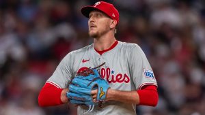 Philadelphia Phillies pitcher Jeff Hoffman checks the scoreboard in the seventh inning of a baseball game against the Atlanta Braves, Wednesday, Aug. 21, 2024, in Atlanta. (AP Photo/Jason Allen)