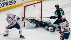 Edmonton Oilers center Jeff Skinner (53) scores against Seattle Kraken goaltender Philipp Grubauer, center, as Kraken defenseman Vince Dunn (29) looks on during the first period of an NHL hockey game. (Lindsey Wasson/AP)