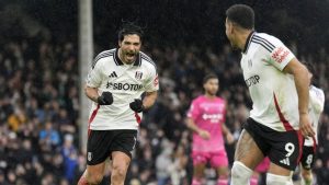 Fulham's Raul Jimenez, left, celebrates after scoring his sides first goal from the penalty spot during the English Premier League soccer match between Fulham and Ipswich Town at Craven Cottage stadium, London, Sunday Jan. 5, 2025. (Andrew Matthews/PA via AP)