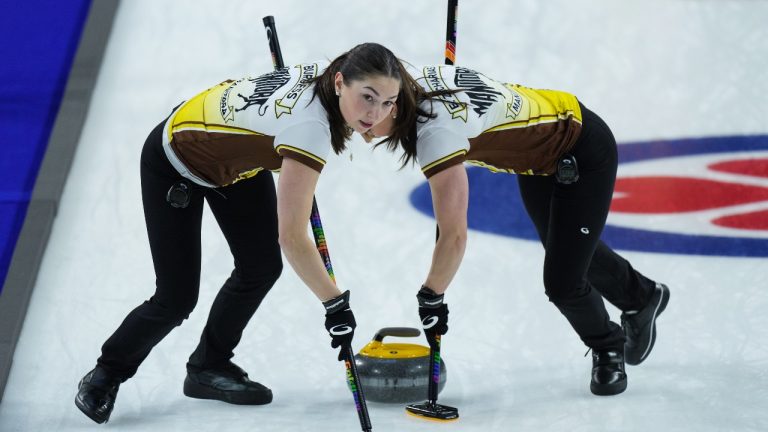 Manitoba third Karlee Burgess, front left, and second Mackenzie Zacharias sweep while playing Team Wildcard 3 at the Scotties Tournament of Hearts, in Kamloops, B.C., on Sunday, February 19, 2023. (THE CANADIAN PRESS/Darryl Dyck)