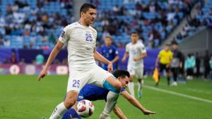 Uzbekistan's Abdukodir Khusanov, and Thailand's Supachok Sarachat, rear, vie for the ball during the Asian Cup round of 16 soccer match between Uzbekistan and Thailand at Al Janoub Stadium in Al Wakrah, Qatar, Tuesday, Jan. 30, 2024. (Aijaz Rahi/AP)