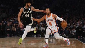 New York Knicks' Jalen Brunson, right, dribbles past Milwaukee Bucks' Andre Jackson Jr., left, during the first half of an NBA basketball game Sunday, Jan. 12, 2025, in New York. (AP Photo/Pamela Smith)