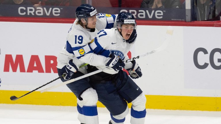 Finland forward Konsta Helenius(19) hugs Benjamin Rautiainen (37) as he celebrates his game winning goal during semi-final action against Sweden at the IIHF World Junior Hockey Championship tournament in Ottawa, Saturday, Jan. 4, 2025. (Adrian Wyld/CP)