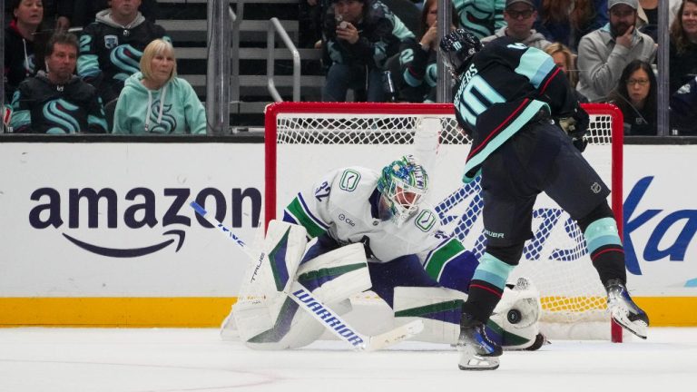 Vancouver Canucks goaltender Kevin Lankinen makes a save against Seattle Kraken center Matty Beniers (10) during a shootout for a 4-3 Canucks win in an NHL hockey game. (Lindsey Wasson/AP)