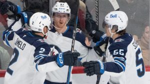 Winnipeg Jets' Kyle Connor (centre) celebrates his goal over the Montreal Canadiens with teammates Dylan DeMelo (2) and Mark Scheifele (55) during first period NHL hockey action in Montreal on Tuesday, Jan. 28, 2025. (Christinne Muschi/CP)