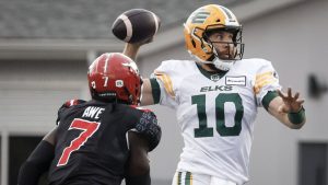 Edmonton Elks quarterback McLeod Bethel-Thompson (10) throws the ball as Calgary Stampeders' Awe Micah (7) closes in during second half CFL football action in Calgary, Monday, Sept. 2, 2024. (Jeff McIntosh/CP)