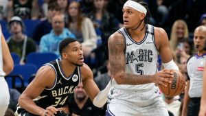 Orlando Magic forward Paolo Banchero (5) looks to pass the ball as Milwaukee Bucks forward Giannis Antetokounmpo (34) defends during the first half of an NBA basketball game, Friday, Jan. 10, 2025, in Orlando, Fla. (AP Photo/John Raoux)