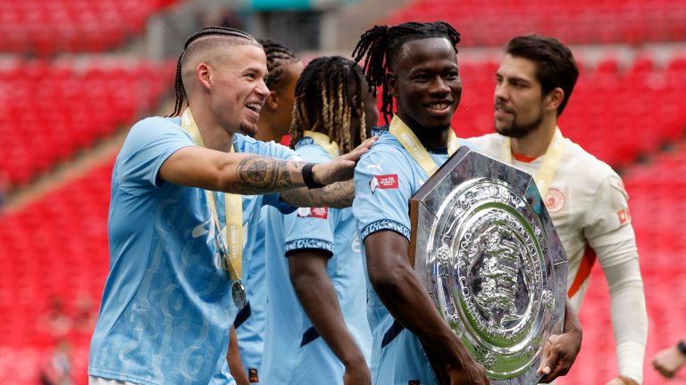 Manchester City's Issa Kabore celebrates with the trophy after his team won the FA Community Shield soccer match between Manchester City and Manchester United at Wembley Stadium in London, Saturday, Aug. 10, 2024. (AP Photo/David Cliff)