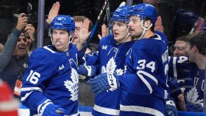 Toronto Maple Leafs left wing Matthew Knies (23) celebrates his goal with teammates Mitch Marner (16) and Auston Matthews (34) during second period NHL hockey action against the Boston Bruins, in Toronto, Saturday, Jan. 4, 2025. (Frank Gunn/CP)