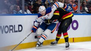 Edmonton Oilers' Connor McDavid (97) and Vancouver Canucks' Elias Pettersson (40) vie for the puck during the third period of an NHL hockey game in Vancouver, on Saturday, January 18, 2025. (Ethan Cairns/CP)