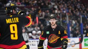 Vancouver Canucks' Elias Pettersson listens to instructions from J.T. Miller before a faceoff during the first period of an NHL hockey game against the New Jersey Devils, in Vancouver, on Wednesday, October 30, 2024. (Darryl Dyck/CP)