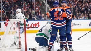 Vancouver Canucks goalie Thatcher Demko (35) is scored on as Edmonton Oilers' Corey Perry (90) and Zach Hyman (18) celebrate during second period NHL action in Edmonton on Thursday, January 23, 2025. (Jason Franson/CP)