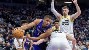 Sacramento Kings center Orlando Robinson, front left, looks to pass the ball around Utah Jazz forward Drew Eubanks, front right, during the first half of an NBA basketball game Sunday, Dec. 8, 2024, in Sacramento, Calif. (Sara Nevis/AP)