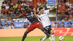 Toronto FC forward Prince Osei Owusu (99) and D.C. United defender Aaron Herrera (22) vie for possession of the ball during MLS action in Toronto on Saturday, August 31, 2024. (Christopher Katsarov/CP)