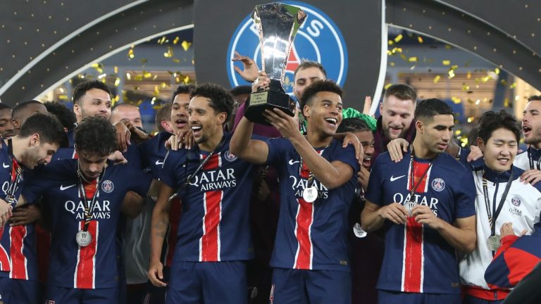 PSG players celebrate with a trophy after the French Super Cup final match between Paris Saint Germain and Monaco in Doha, Qatar, on Sunday, Jan. 5, 2025.(Hussein Sayed/AP)